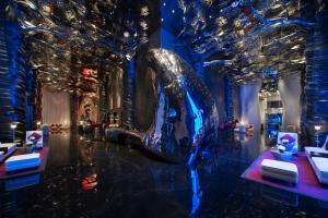 a large silver whale sculpture in a room with trees at Banyan Tree Doha At La Cigale Mushaireb in Doha