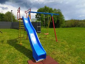 a playground with a blue slide and a ladder at Villa Heaven Green in Pazin
