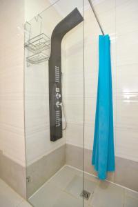 a bathroom with a blow dryer in a shower at Victoria Center Apartments in Budva +108 photos