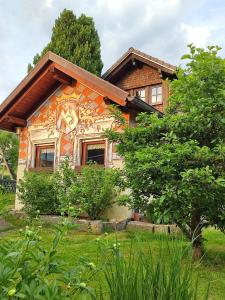 a house with a painting on the side of it at Webers Ferienwohnungen in Hilders