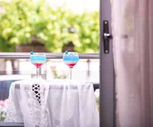 two wine glasses sitting on a table in front of a window at Denisa Studios in Sarti
