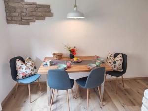 a dining room table with four chairs around it at Webers Ferienwohnungen in Hilders