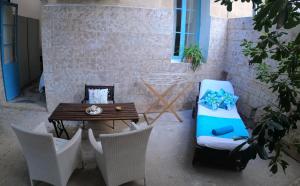 a patio with a table and chairs and a table at The Maltese Sun in Sliema