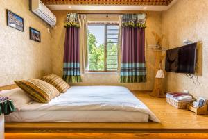 Postel nebo postele na pokoji v ubytování Hangzhou Citynest Music B&B