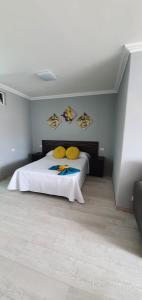 a bedroom with a bed with yellow pillows on it at Green Park in San Miguel de Abona