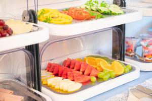 an open refrigerator filled with fruits and vegetables at Hotel Astoria am Urachplatz in Stuttgart