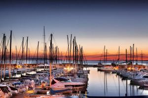 a group of boats docked in a marina at sunset at Marina di Scarlino Resort in Puntone di Scarlino
