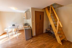 a kitchen and dining room with a staircase in a apartment at Pensjonat Lido in Antonin