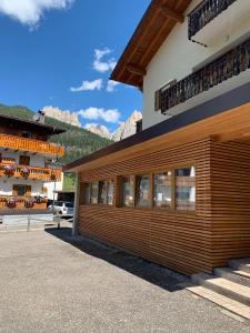 a building with a bunch of windows on it at Ciasa De Rosa in Pozza di Fassa