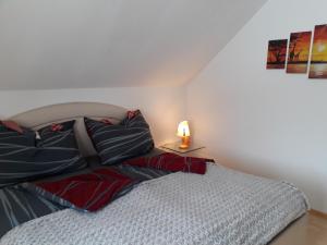 a bedroom with a bed and a lamp on a table at Ferienwohnung Am Sonnenweg in Stanz Im Murztal