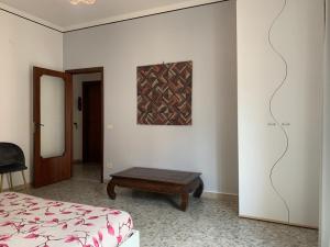a bedroom with a bed and a table and a painting at Sorrento Soul in Sorrento