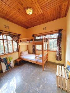 
a small room with a wooden floor and wooden walls at Mazzola Safari House & Backpacking in Arusha
