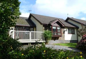 a house with a porch and a balcony at Valley Retreat - Peaceful Location, Walk to Beach, Parking in Saundersfoot