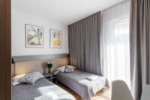 Posteľ alebo postele v izbe v ubytovaní Wolska Residence I