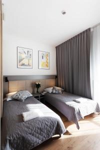 Posteľ alebo postele v izbe v ubytovaní Wolska Residence I