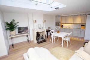 a living room with a white couch and a table at Aan Zee en Duin in Egmond aan Zee +24 photos