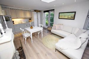 a living room with a white couch and a table at Aan Zee en Duin in Egmond aan Zee