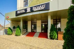 a hotel entrance with a red carpet in front of it at Hotel Vision in Krasnodar