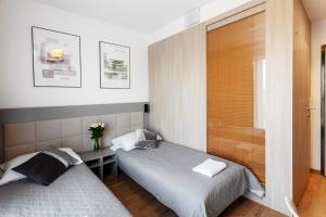 Posteľ alebo postele v izbe v ubytovaní Wolska Residence I