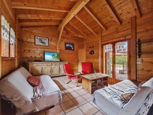 a living room with two couches and a television in a cabin at CHALET-MORZINE-6 a 18 PERSONNES-SAUNA -PROCHE NAVETTE et BOULANGERIE-MANUPA CLEVIE in Morzine