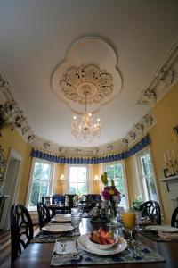 a dining room with a table with a chandelier at Rockwood Manor Bed & Breakfast in Dublin
