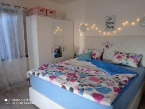 a bedroom with a large bed with a floral comforter at Apartment Lili in Lukovo