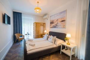 a living room with a couch and a table at Csenge Villa in Siófok