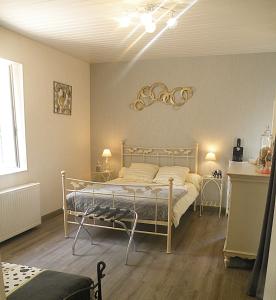 a bedroom with a bed and two end tables at L'Escale in La Jarrie