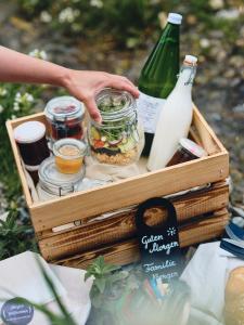 a wooden crate with food and a bottle of milk at Haus am Sonnenhang by Schladming-Appartements in Schladming