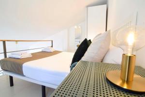 a bedroom with a bed and a table with a lamp at Letmalaga Economy Jábega in Málaga