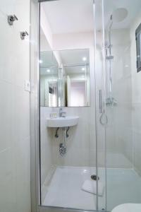 a white bathroom with a shower and a sink at Letmalaga Economy Jábega in Málaga