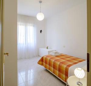 A bed or beds in a room at Appartamento Zappacenere
