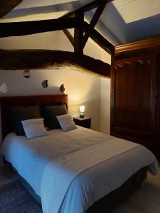 a bedroom with a large bed with a wooden headboard at Logis Des Bessons in Migron +41 photos