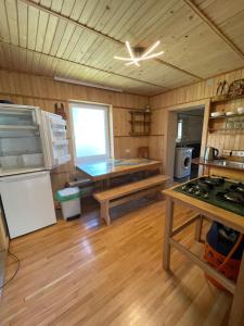 a kitchen with a refrigerator and a table in a room at Прикарпаття in Kosiv