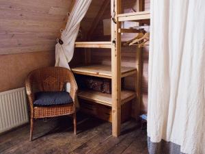a room with a bunk bed and a chair at La Roquette-Chambre d'hôtes in Grand-Vabre