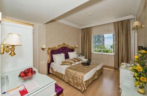 a bedroom with a bed with a laptop on it at Santa Sophia Hotel - İstanbul in Istanbul +39 photos
