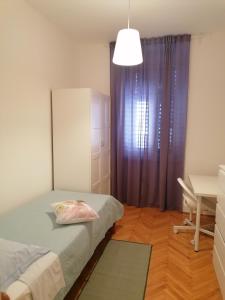 Un pat sau paturi într-o cameră la Margherita