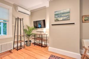 a living room with a door and a plant at Charming Abode with Patio - Walk to Town and River! in Stockton