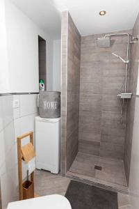 a bathroom with a shower with a toilet and a sink at Studio La Concha direkt am Meer in Torrox Costa +9 photos