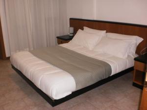 
a hotel room with a bed and two nightstands at RTA Le Corti in Grosseto
