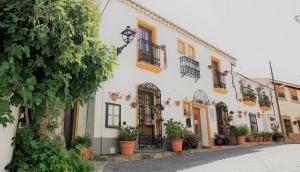 a row of buildings with potted plants on a street at Casona Granado in El Pilar y Provincias