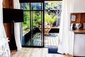 a kitchen with a sliding glass door to a patio at Beach House in Lège-Cap-Ferret