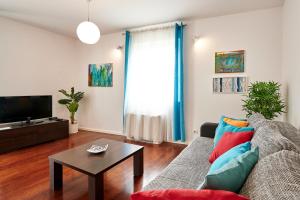 a living room with a couch and a table at Apartments Gea Trogir in Trogir