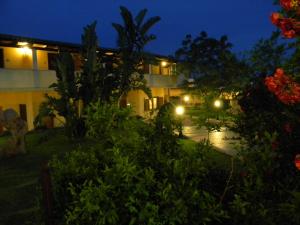 a view of a building at night with lights at Relais Fenicottero Rosa in Porto San Paolo