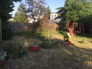 a yard with a garden with a playground and plants at U Babci in Stegna