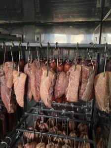 a bunch of meat hanging on a rack at Pensiunea Trei Lalele in Moisei