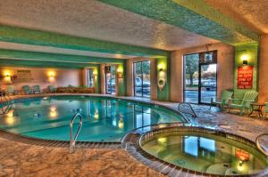 a pool in the middle of a hotel room at MCM Elegante Suites Abilene in Abilene