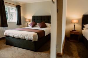 聖大衛的住宿－老十字酒店，一间卧室设有一张大床和一个窗户。