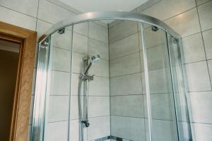 a shower with a shower head in a bathroom at St. Davids Cross Hotel in St. Davids +71 photos
