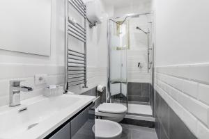 a bathroom with a toilet and a sink and a shower at Roma House Piramide in Rome +25 photos